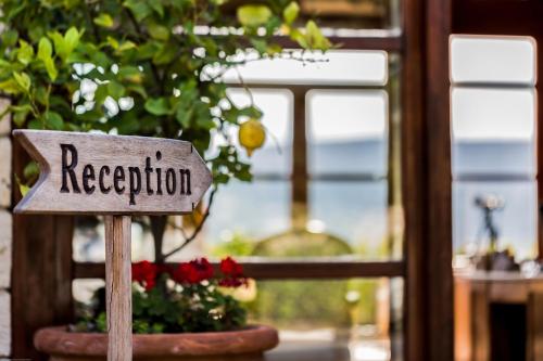 a sign that says reception in front of a window at Alacati Kapari Hotel - Special Category in Alacati