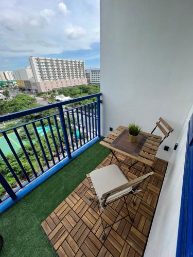 a balcony with a table and a chair on a balcony at Sea Residences: Eyal’s Suite Condotel near MOA/Mall of Asia in Manila