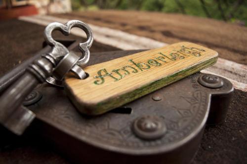 a key on top of a wooden object with a happy birthday sign at Hacienda Rumiloma in Quito