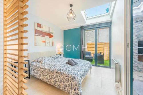 ein Schlafzimmer mit einem Bett in einem Zimmer mit blauen Wänden in der Unterkunft Cosy lounge suit à 10 min de l'aéroport CDG TREMBLAY EN FRANCE in Tremblay En France