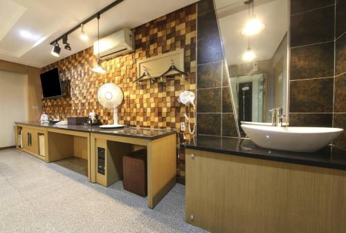 a bathroom with a sink and a mirror at Q5 Hotel Busan Songdo in Busan