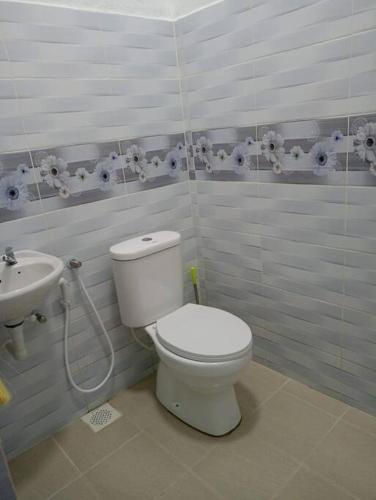 a bathroom with a toilet and a sink at Homestay Usrati 17J (untuk muslims sahaja) in Kangar