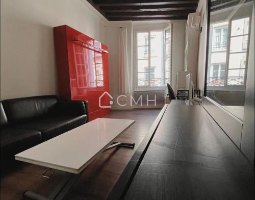 un salon avec un canapé et une table basse dans l'établissement Studio Paisible - En plein coeur de Paris, à Paris