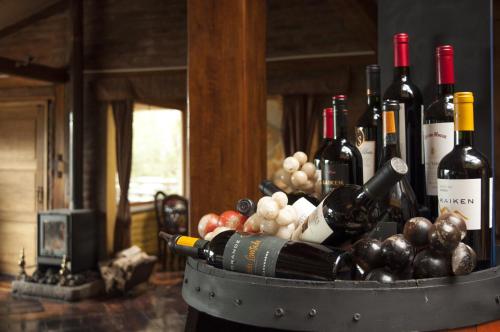 a barrel filled with bottles of wine and grapes at Hacienda Rumiloma in Quito