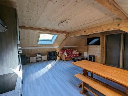 un grand salon avec une table et un canapé dans l'établissement LE GRENIER, à La Bresse