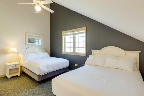 a bedroom with two beds and a window at Beautiful Day Getaway - Lake Michigan Views in Sheboygan