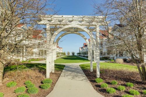 a white arch in a park with a sidewalk at Beautiful Day Getaway - Lake Michigan Views in Sheboygan