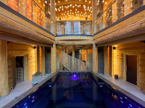 an indoor swimming pool in a building with lights at SKOGUR - Home & Resort in Bukovel