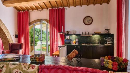 a living room with red curtains and a table at Belvedere in Castel Viscardo