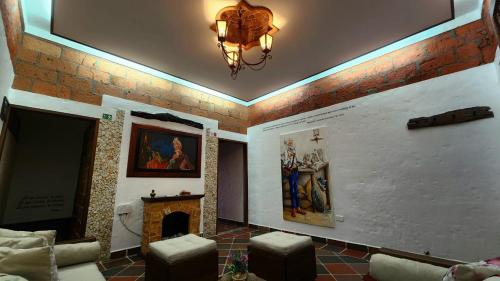 a living room with a fireplace and a chandelier at El Quijote Apartahotel in Jericó