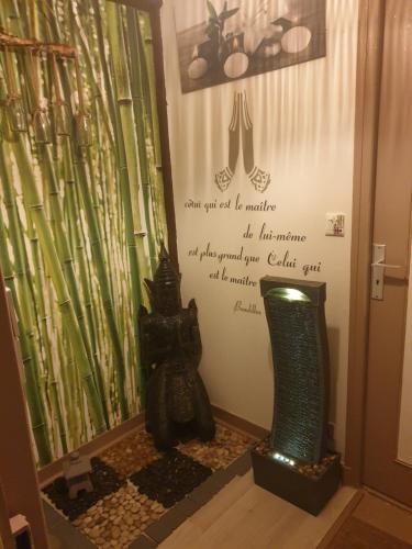 a room with a sign on the wall with bamboo at Le Mouton Gras in Aumale