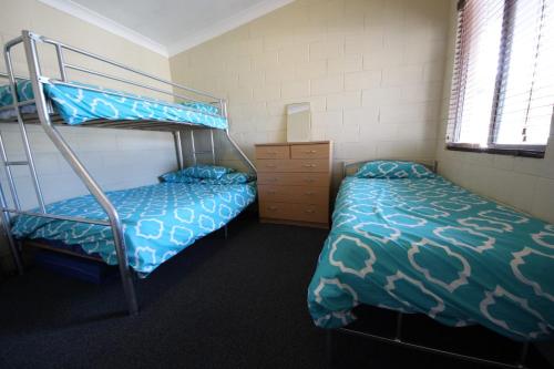 a bedroom with two bunk beds and a dresser at Beach Unit 7 at Hat Head in Hat Head