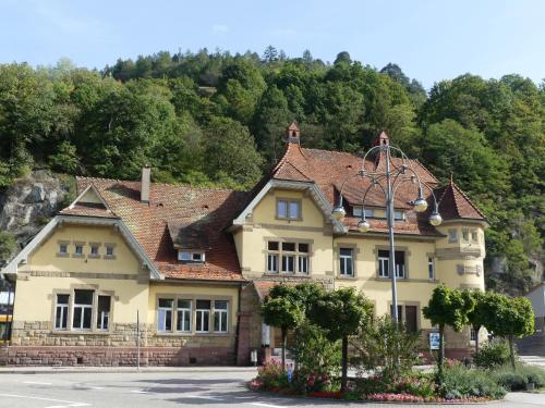 a large yellow house with a brown roof at Ferienwohnungen Sonnenhalde mit schöner Aussicht in Forbach