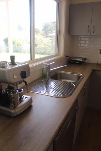 a kitchen counter with a sink and a mixer at Frog Hollow Hat Head 3 Oak St -No Sheets or Towels Provided in Hat Head