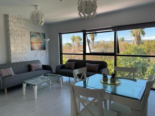 a living room with a couch and a table at TECNOCORDOBA II aparcamiento privado gratuito y piscina in Córdoba