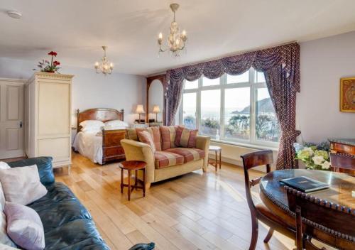 a bedroom with a bed and a living room at Kilmorie Lodge in Torquay