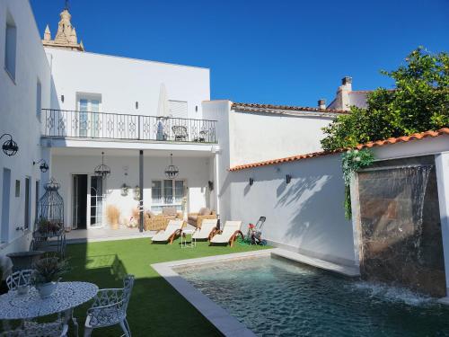 une cour avec une piscine dans une maison dans l'établissement Hotel Boutique IULIA 5 Estrellas Premium, à Zafra