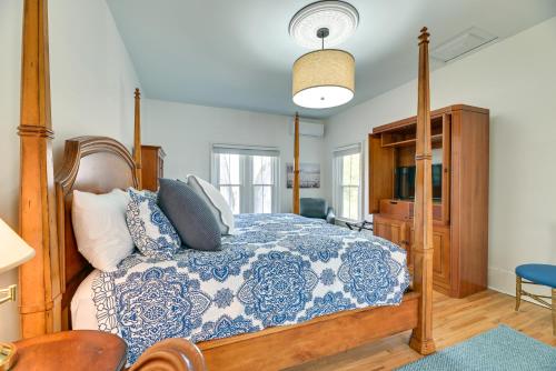 a bedroom with a bed with a blue and white comforter at Spacious Naples Vacation Rental with Private Hot Tub in Naples