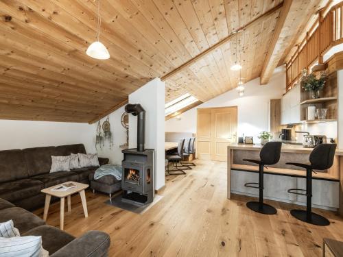 a living room with a couch and a stove at Alpenapartments in Ried im Oberinntal