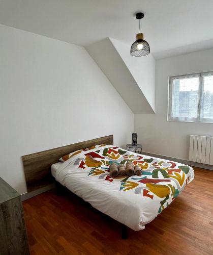 La Haye-du-Puits的住宿－MAISON DE VILLE，一间卧室配有一张带彩色毯子的床