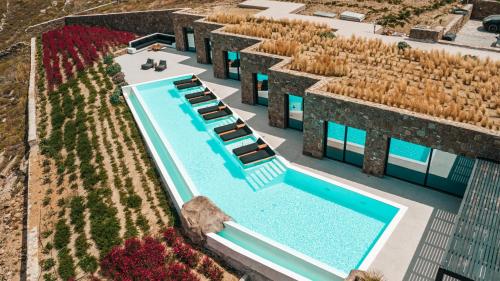 an aerial view of a building with a swimming pool at Mega Mansions Mykonos in Ftelia