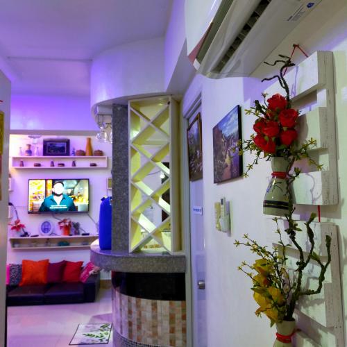 a room with a fireplace and flowers on the wall at Cozy Condo Unit w/ FREE WIFI&Netflix-Pay Parking in Antipolo