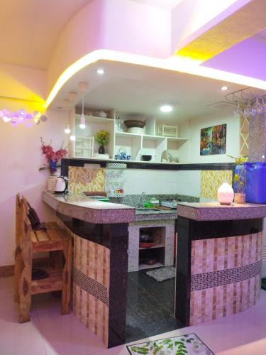 a kitchen with a large island in a room at Cozy Condo Unit w/ FREE WIFI&Netflix-Pay Parking in Antipolo