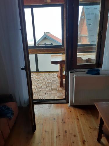 an open door to a room with a view of a kitchen at Vikend kuća Vukašinović in Kopaonik
