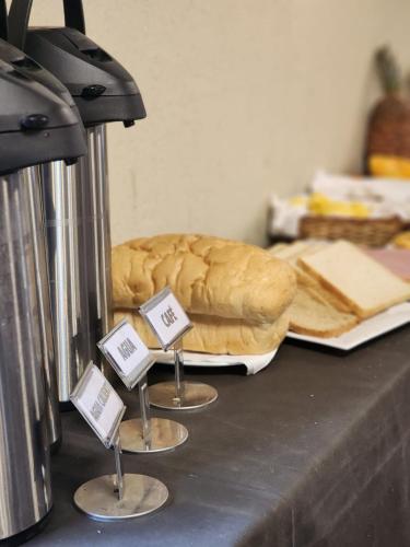 a table with a loaf of bread and signs on it at Hotel Maria in Encarnación