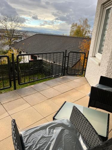 a balcony with a table and chairs and a fence at Sunset Apartment mit Rheinblick in Urbar in Urbar
