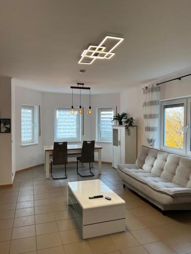 a living room with a couch and a table at Sunset Apartment mit Rheinblick in Urbar in Urbar