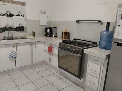 a kitchen with a stove top oven in a kitchen at habitaciones confortables 