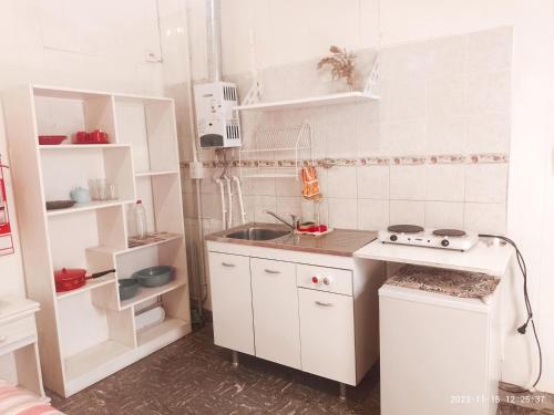 a small kitchen with a sink and a stove at Zafiro Departamentos in Capilla del Monte