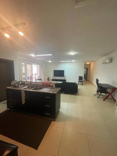 a large room with a kitchen and a living room at Beautiful 2 Bedrooms Apartment - Azaiba in ‘Udhaybah