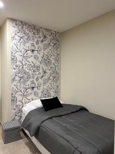 a bedroom with a bed with a floral wallpaper at ESTEPA in Río Gallegos