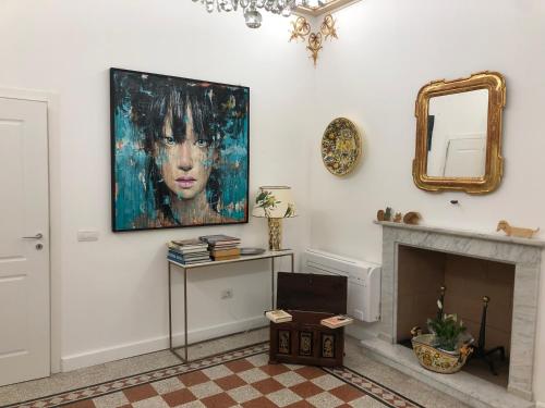 a living room with a painting of a woman on the wall at Casa Buditto in Orvieto