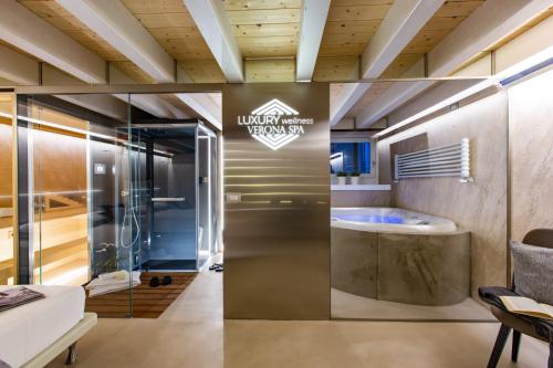 a luxury bathroom with a tub in a room at Luxury Wellness Verona Spa in Verona