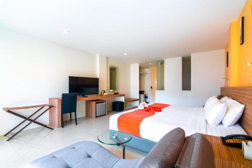 a hotel room with a bed and a couch at The Lantern Resorts Patong - SHA Extra Plus in Patong Beach