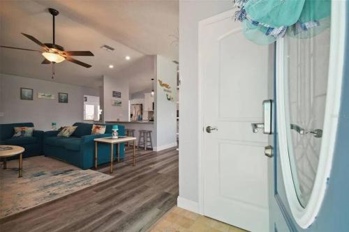 a living room with a blue couch and a ceiling fan at 3bed3bath Waterfront Home with an Amazing View! in Hernando Beach