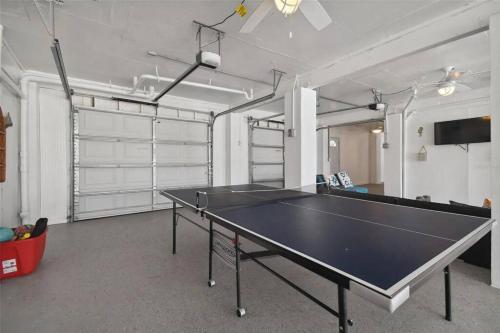 a ping pong table in an empty room with a ping pong ball at 3bed3bath Waterfront Home with an Amazing View! in Hernando Beach