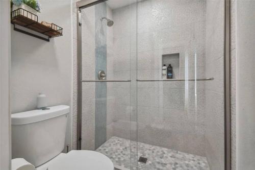 a bathroom with a glass shower with a toilet at 3bed3bath Waterfront Home with an Amazing View! in Hernando Beach