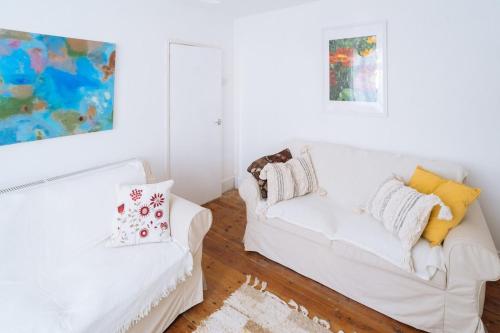 a white living room with a white couch at Peaceful 2BD Home - 18 mins to Bath City Centre! in Bath