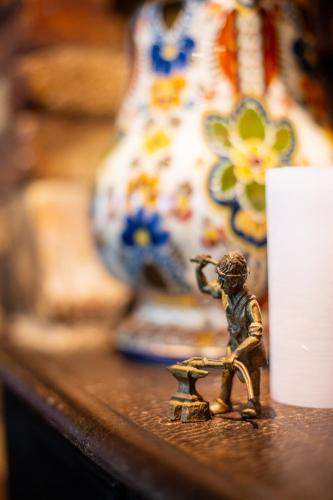 a small figurine sitting on a table next to a vase at De Oude Smidse in Westernieland