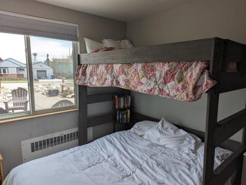 a bedroom with a bunk bed and a window at The Abbey in Leadville