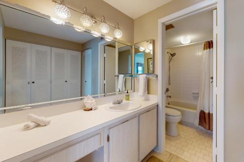 a bathroom with a sink and a toilet at Crystal Waves in Marco Island