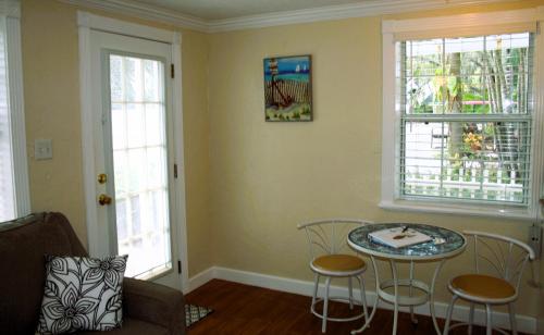 a living room with a table and two windows at Pirates Pointe Resort in Ruskin