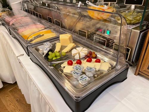 a buffet with cheese and other foods on a table at Boutique Hotel Piano Nobile - am Stubenring in Vienna