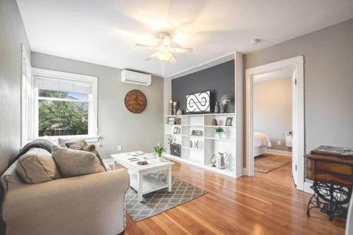 a living room with a couch and a table at Walk to the waterfront! The Cozy Cottage in Tacoma