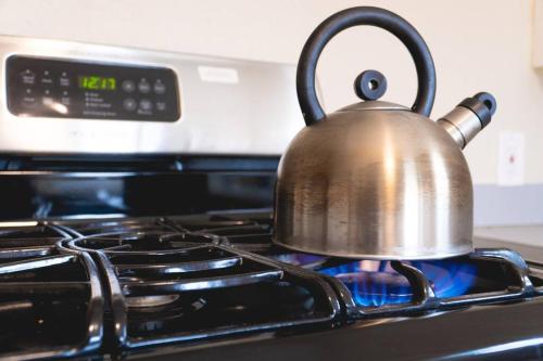 a tea kettle sitting on top of a stove at Walk to the waterfront! The Cozy Cottage in Tacoma