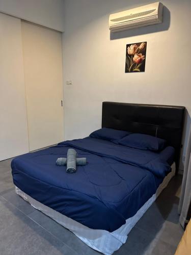 a bed with a blue comforter in a room at Eight Empire Studio (Netflix/Wi-fi) @ IKEA/The Curve in Petaling Jaya